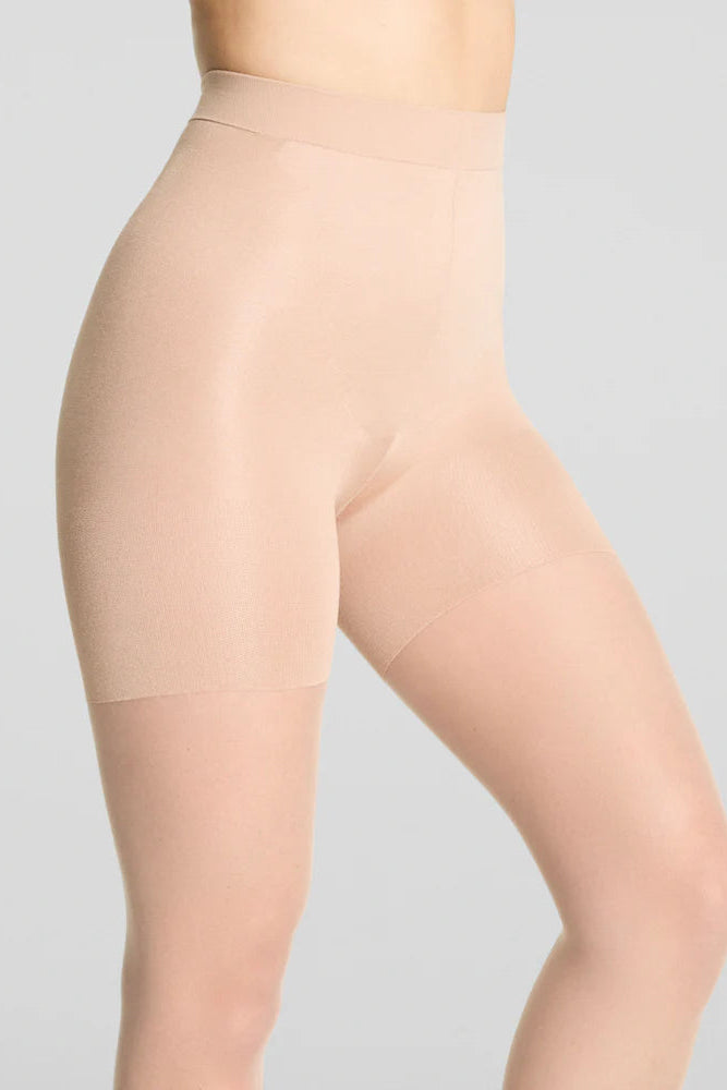 Beige shapewear worn by a person on a light gray background