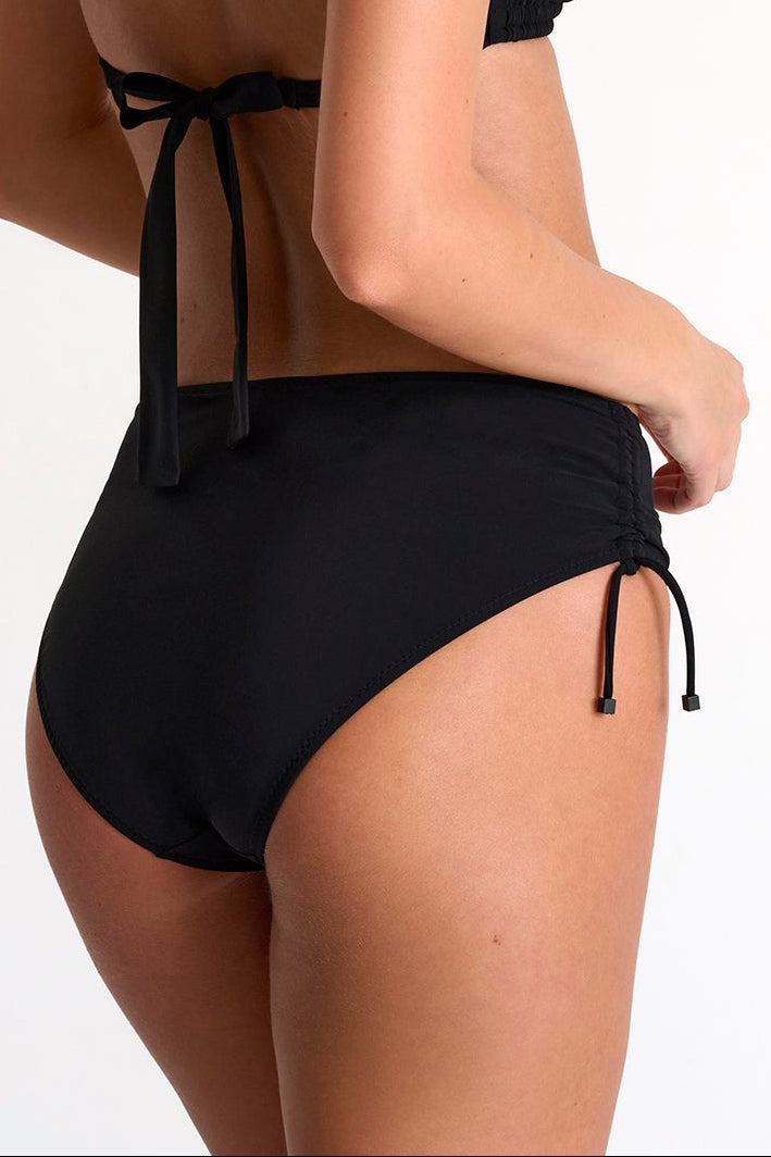 Woman wearing a black bikini on a white background