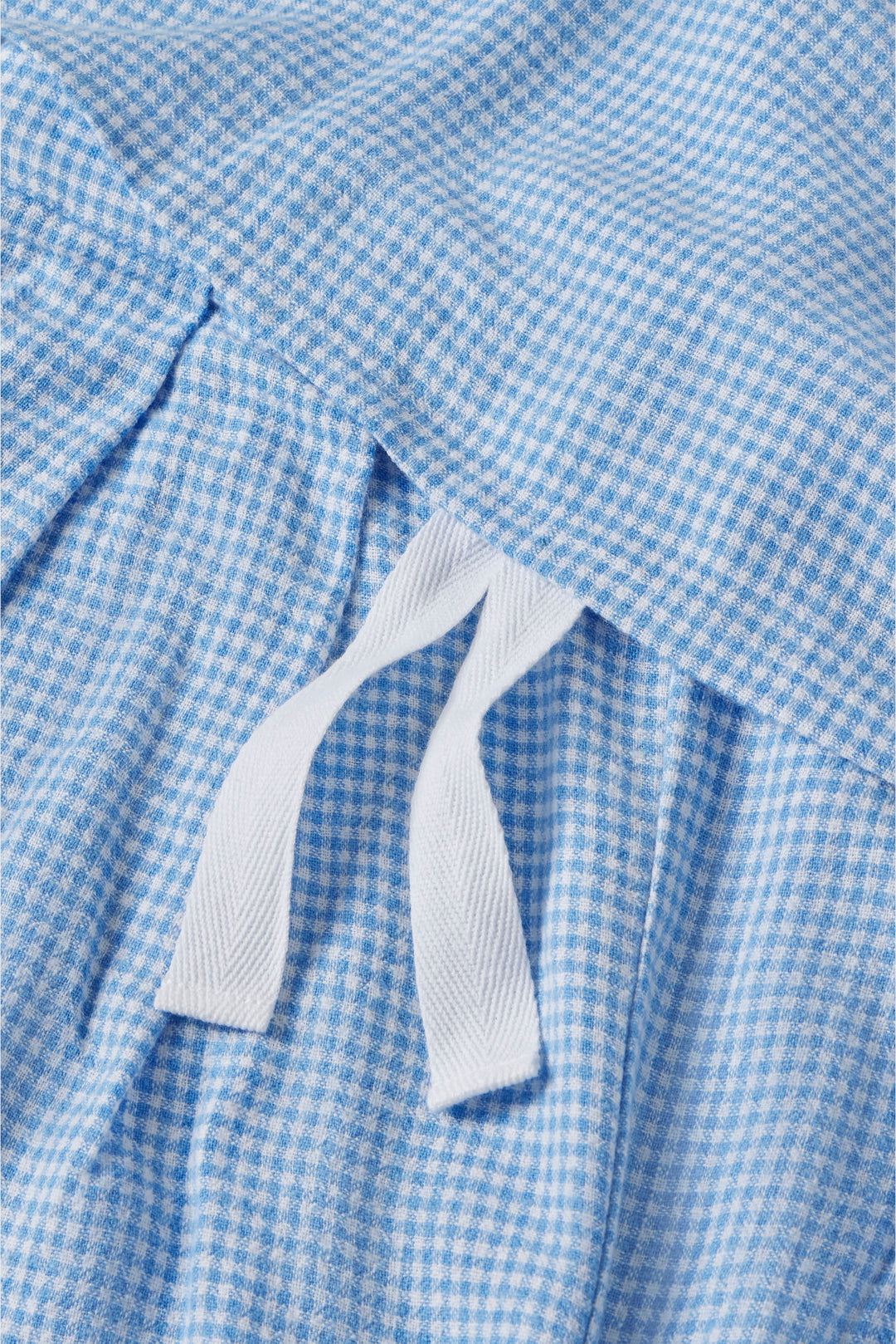 Close-up of a blue checkered fabric with a ribbon detail