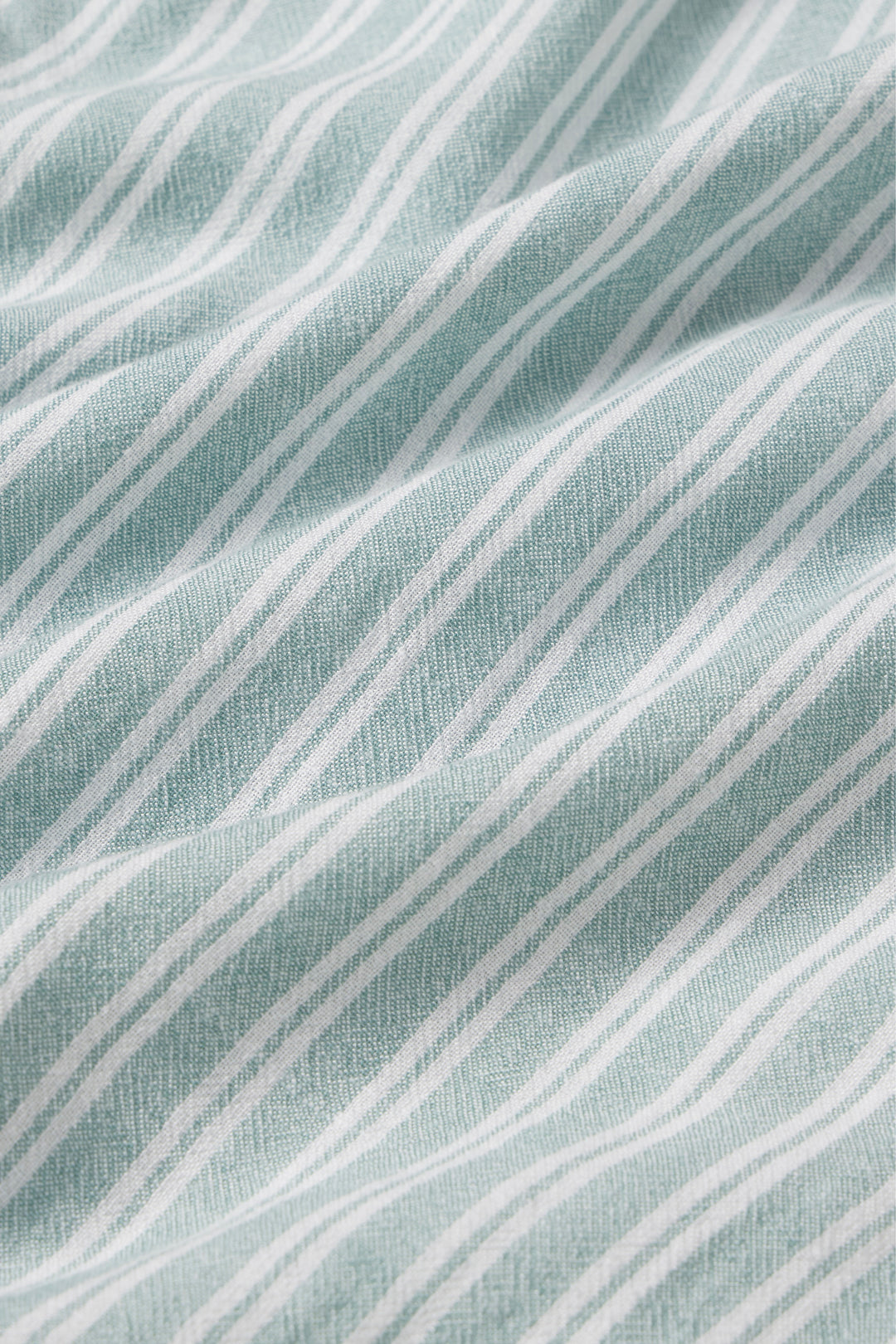 Close-up of a fabric with wavy lines on a textured surface