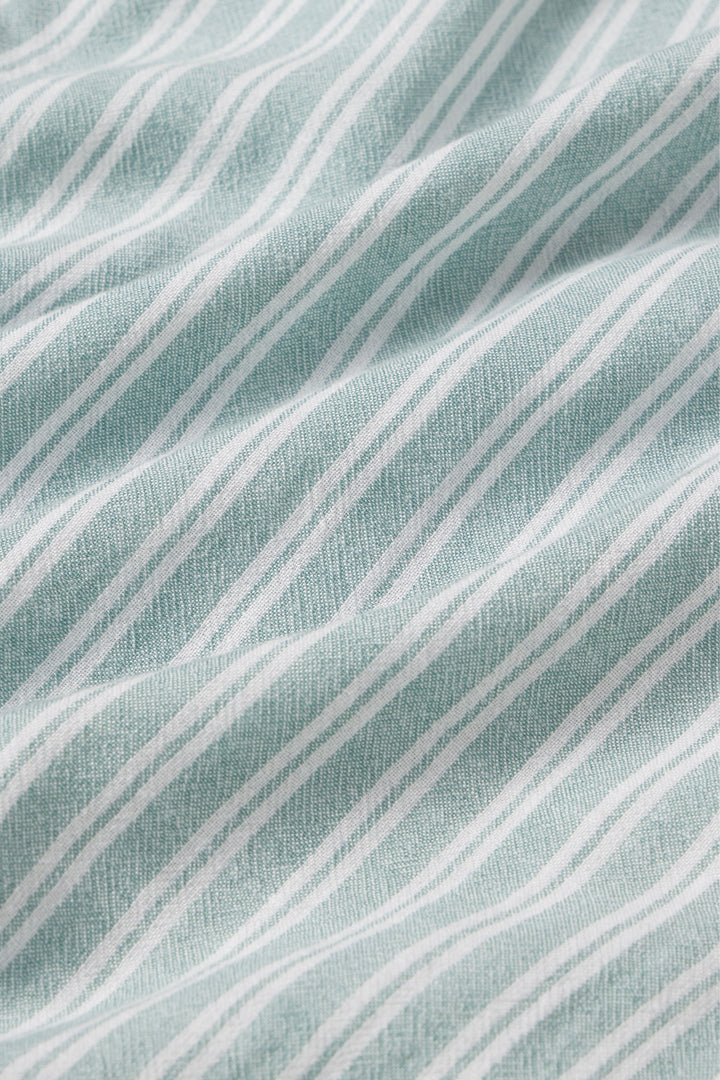 Close-up of a fabric with wavy lines on a textured surface