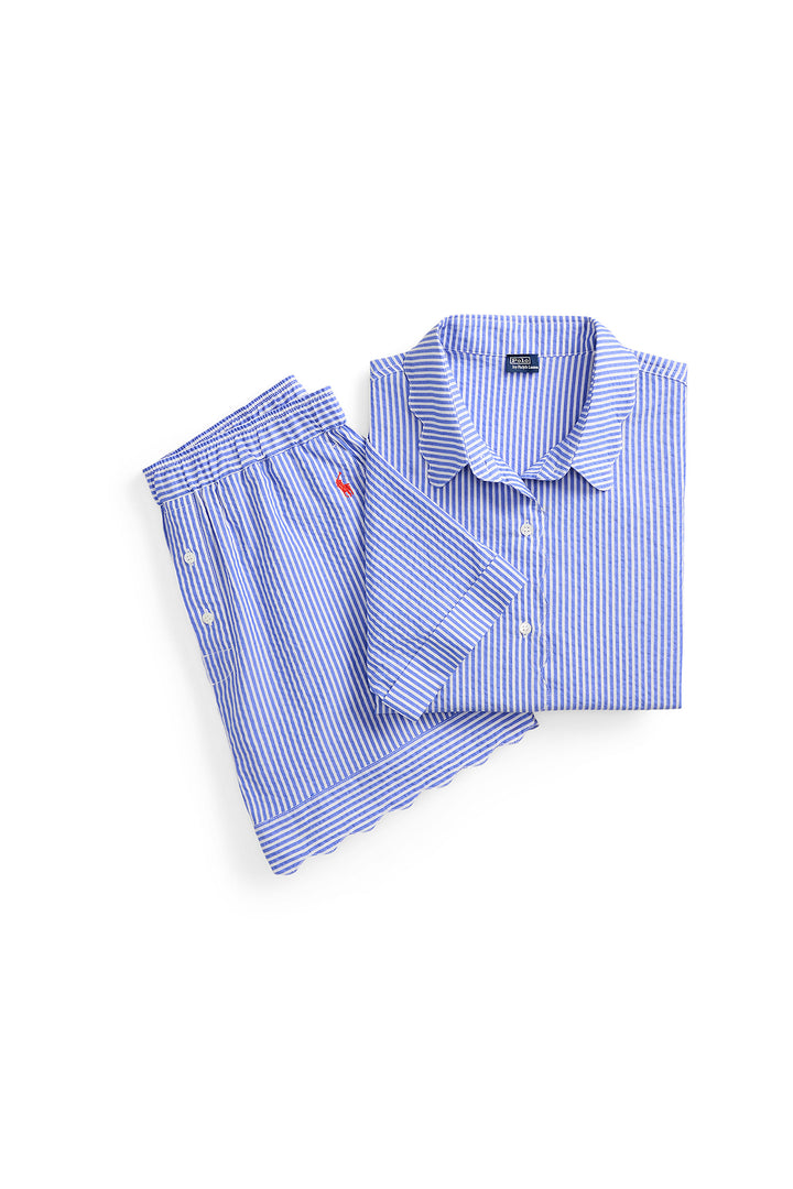 Folded blue and white polo ralph lauren striped pajama shirt and pants on a white background