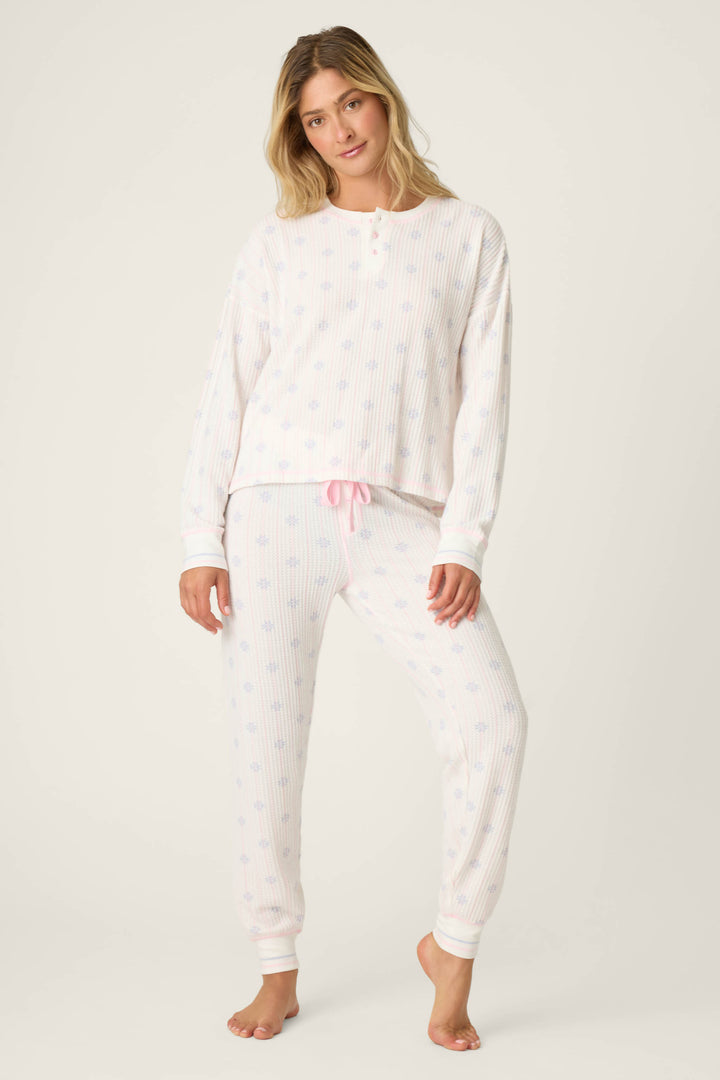 Woman wearing a white long-sleeve top and pants pajama on a white background