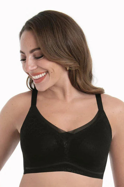 Woman wearing a black bralette on a white background