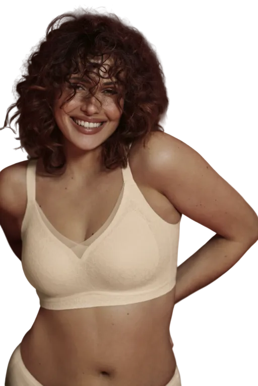Woman wearing a beige bra against a white background