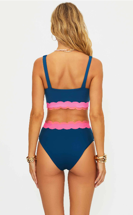 Woman wearing a blue and pink bikini set on a white background
