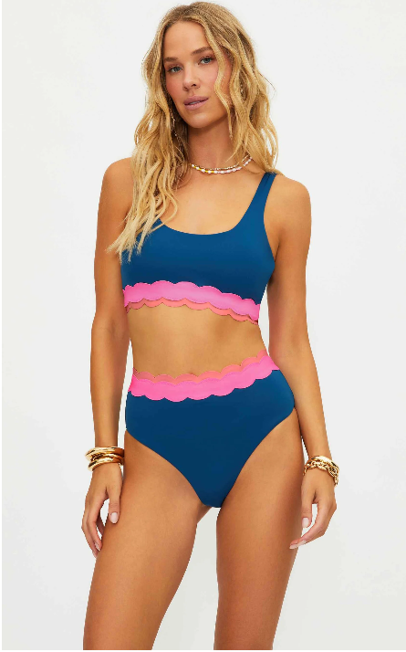 Woman wearing a blue and pink bikini set on a white background