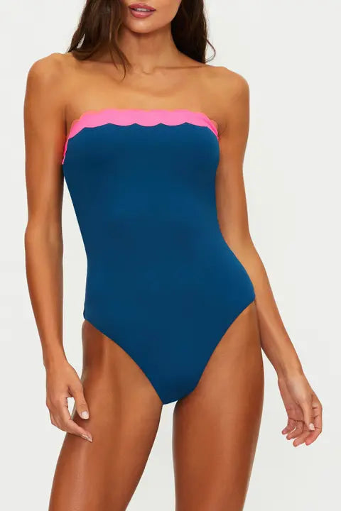 Woman wearing a blue and pink strapless swimsuit on a white background