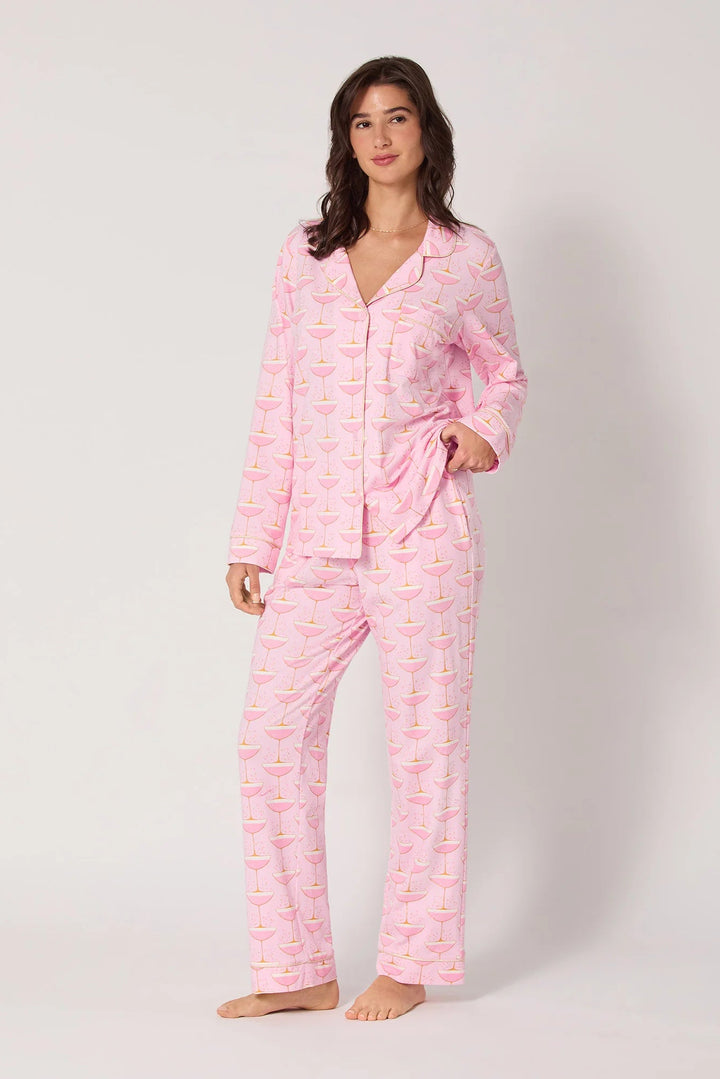 Woman wearing pink champagne  print pajamas with a pattern on a white background