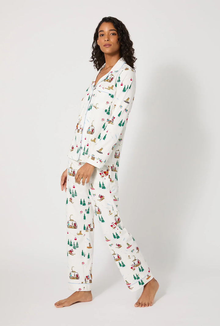 Woman wearing a festive pajama set with a white background