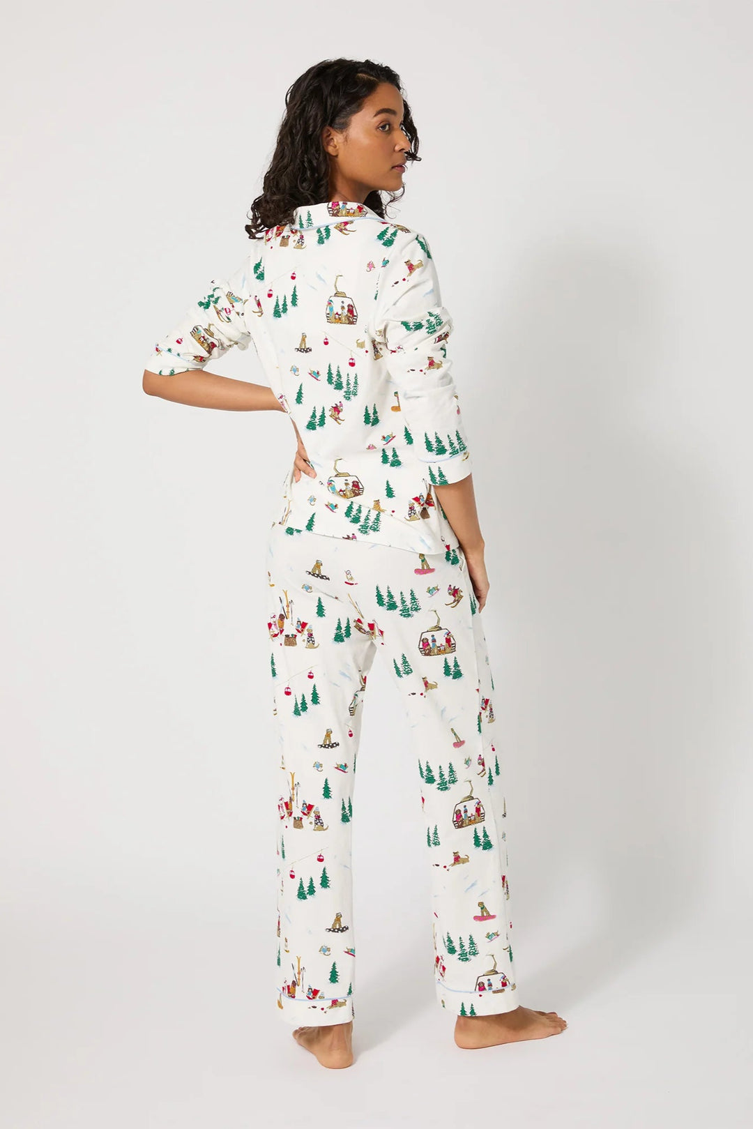 Woman wearing a patterned pajama set on a white background