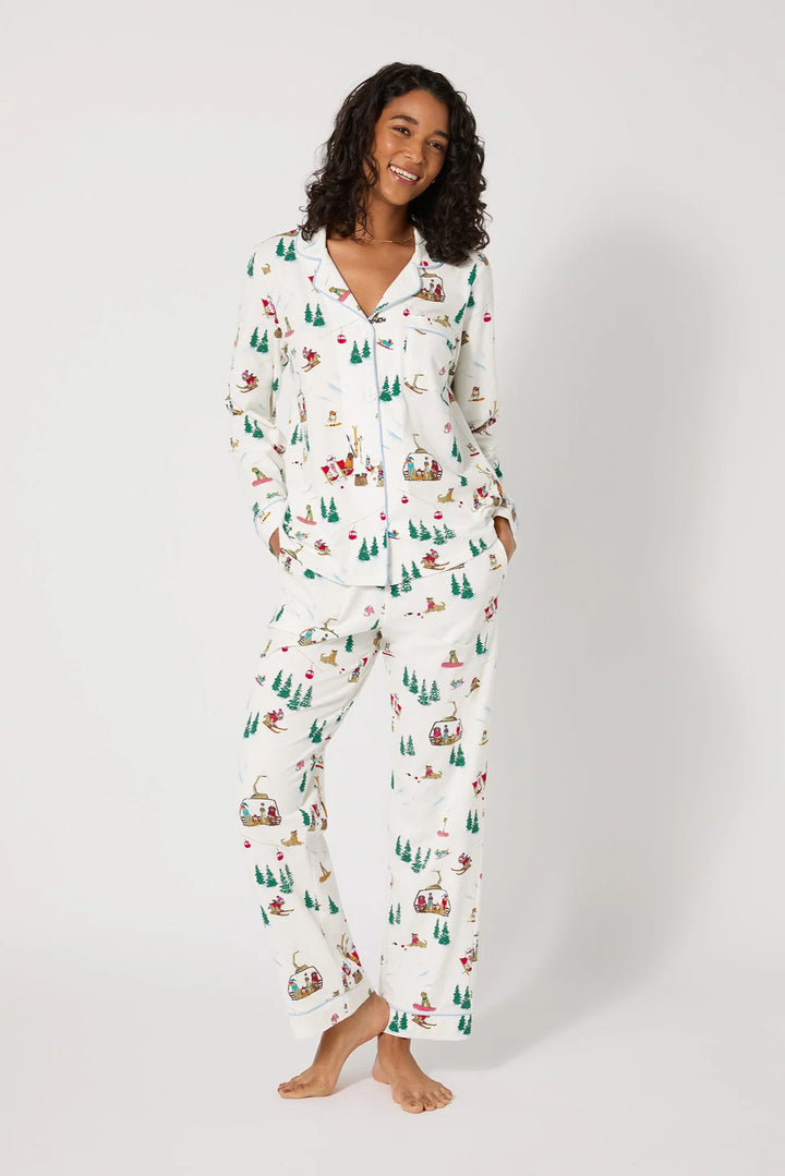 Woman wearing a festive pajama set with a white background