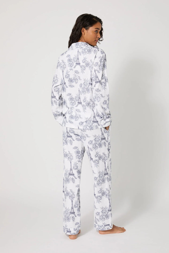 Person wearing a white floral pajama set on a white background