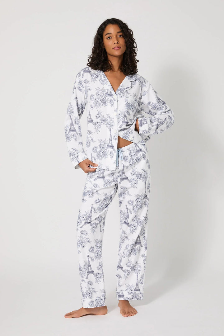 Woman wearing a white floral pajama set on a white background