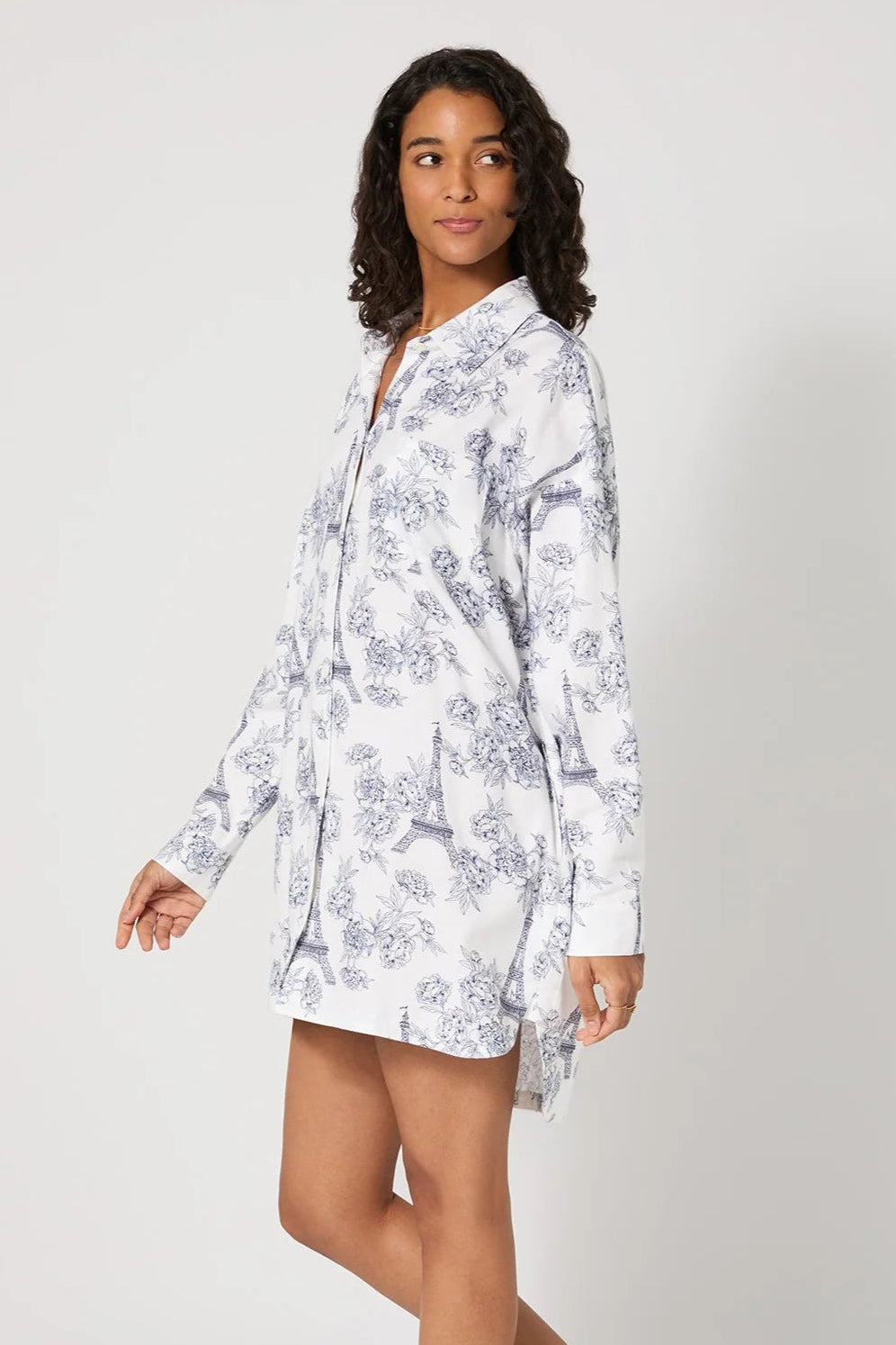 Woman wearing a floral nightshirt on a white background