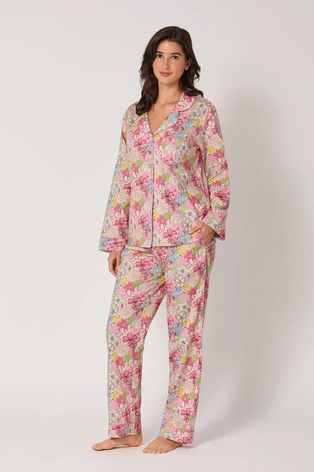 Woman wearing a floral pajama set on a white background