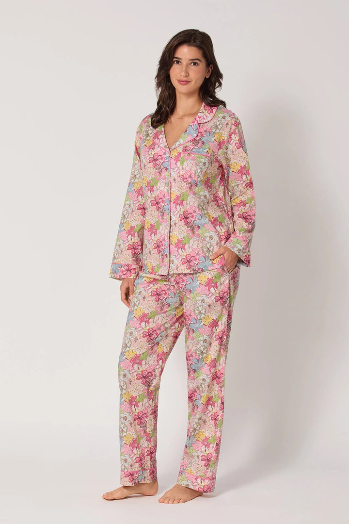 Woman wearing a floral pajama set on a white background