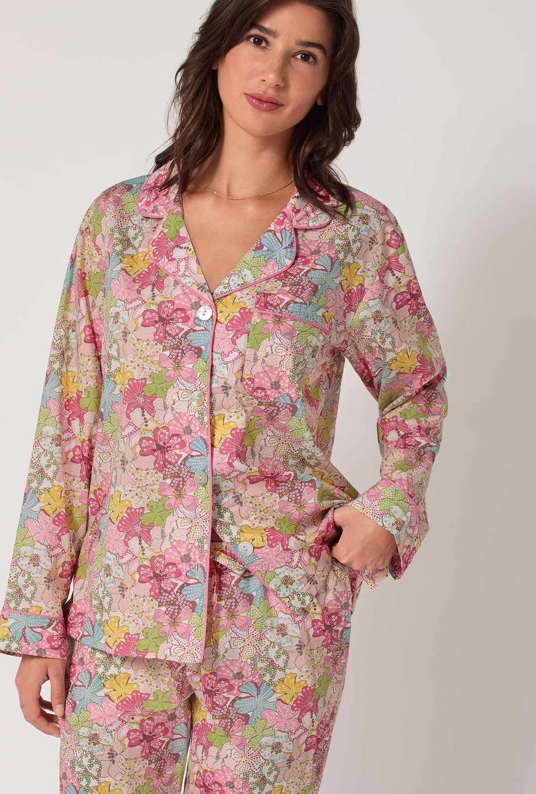 Woman wearing a floral pajama set on a white background
