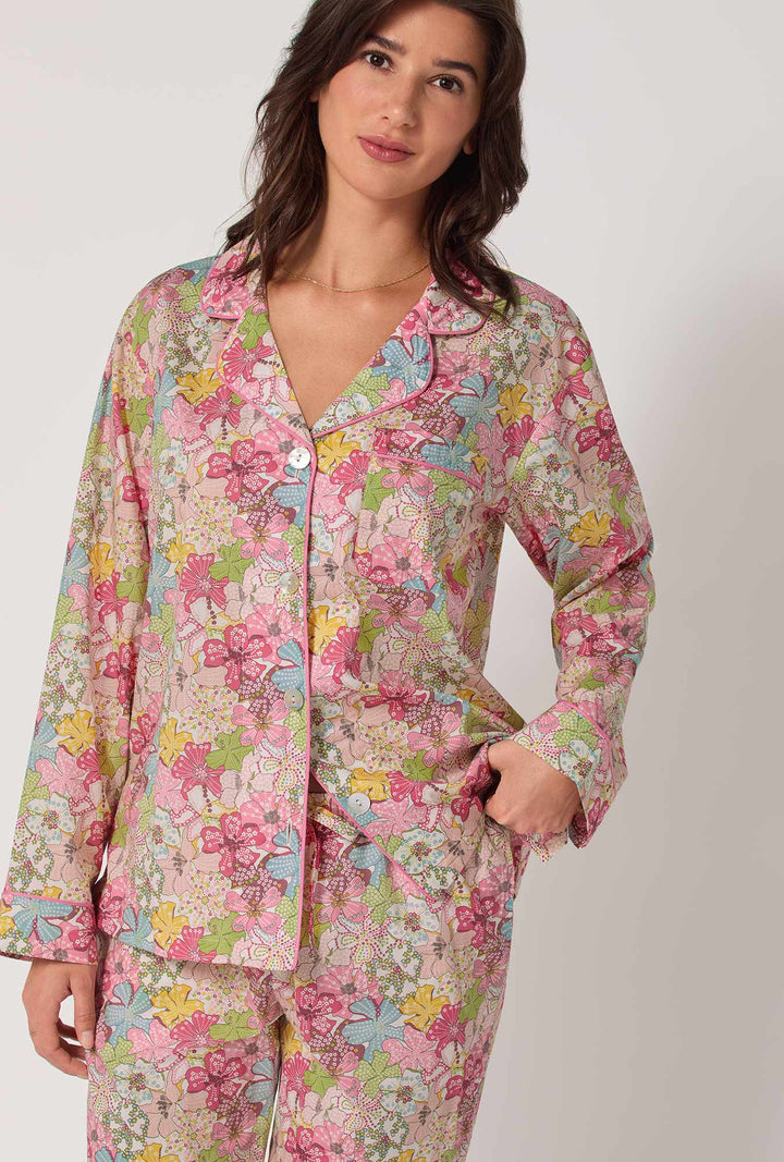 Woman wearing a floral pajama set on a white background