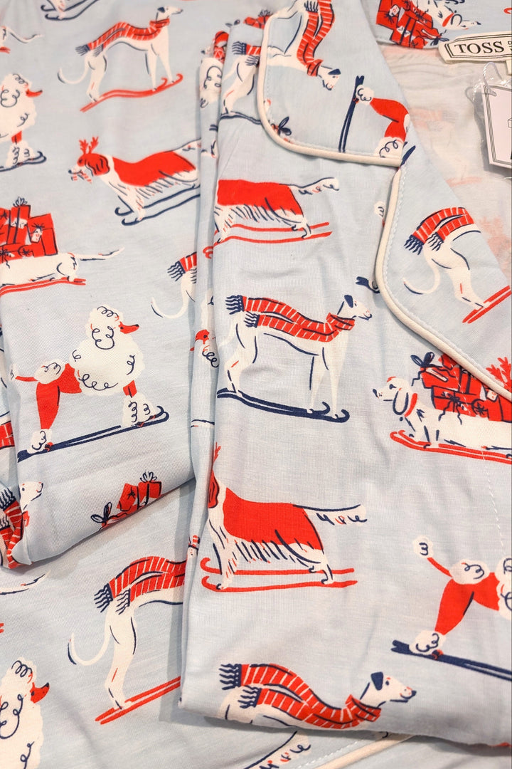 Fabric with red and white dog pattern on light blue background
