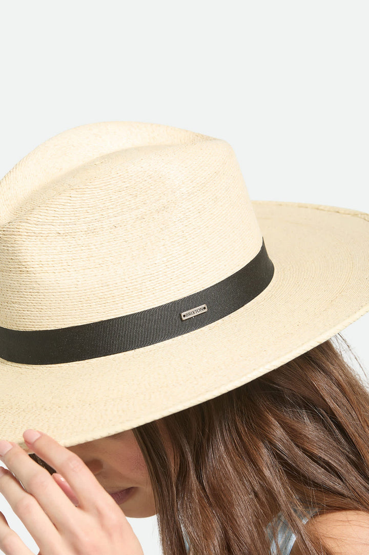 Beige straw hat with a black band on a light gray background