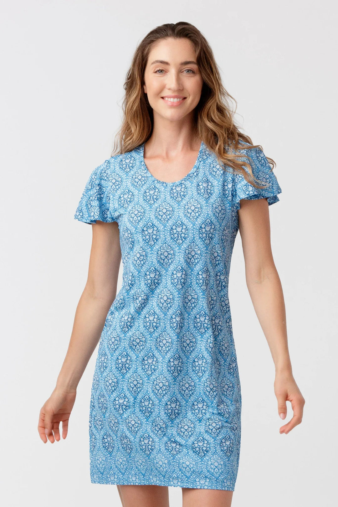 Woman wearing a blue patterned dress on a white background