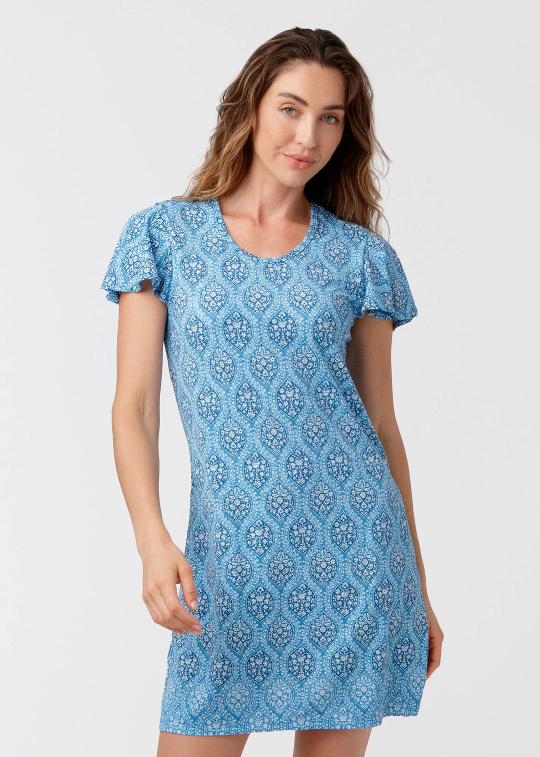 Woman wearing a blue patterned dress on a white background