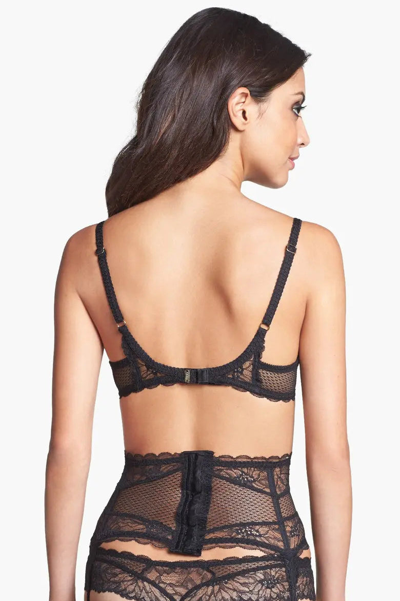 Black lace lingerie set on a model against a white background