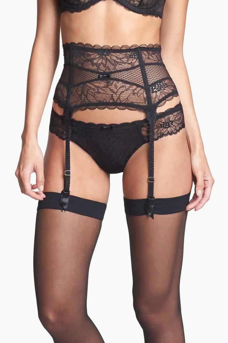 Black lace lingerie set with garters on a white background