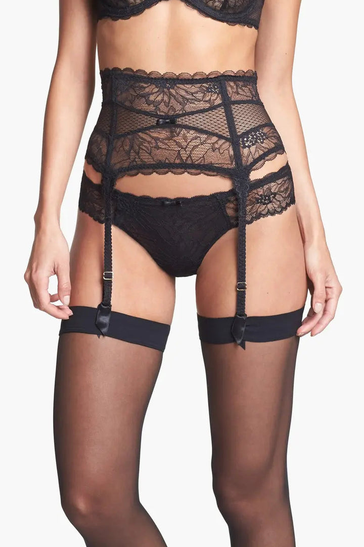 Black lace lingerie set with garters on a white background
