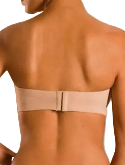 Beige strapless bra worn by a person on a beige background