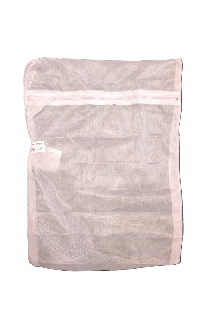 Chantelle mesh wash bag on a tufted gray cushion