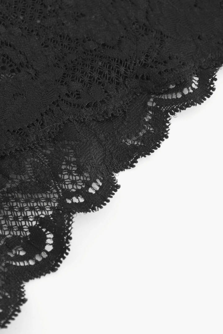 Close-up of black lace fabric on a white background