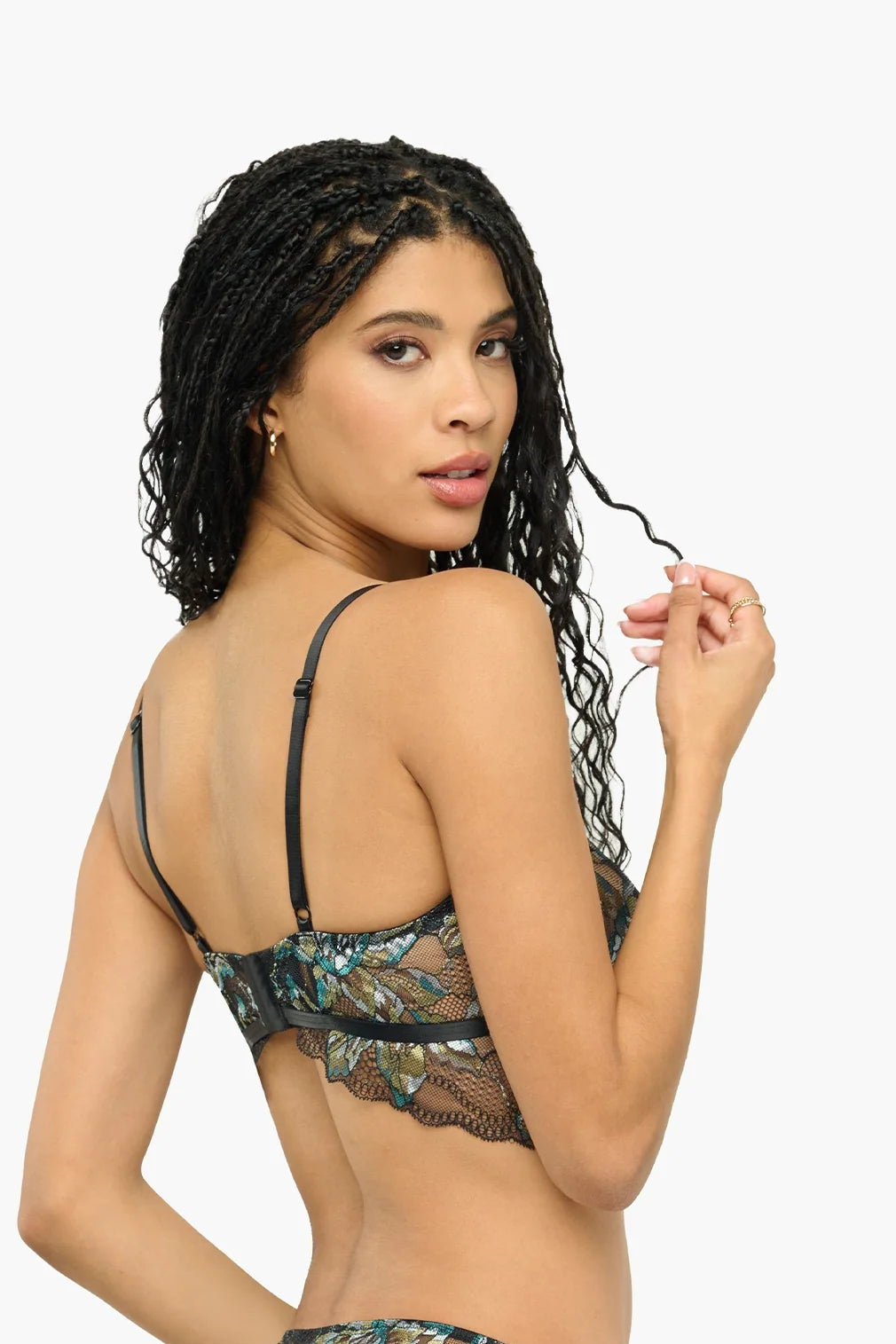 Woman wearing a black lace lingerie set on a white background