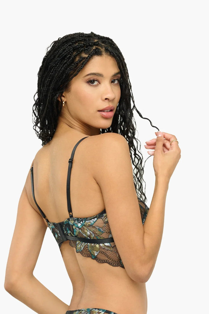 Woman wearing a black lace lingerie set on a white background