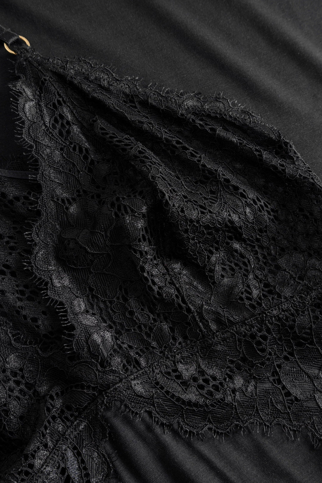 Close-up of black lace fabric with a dark background