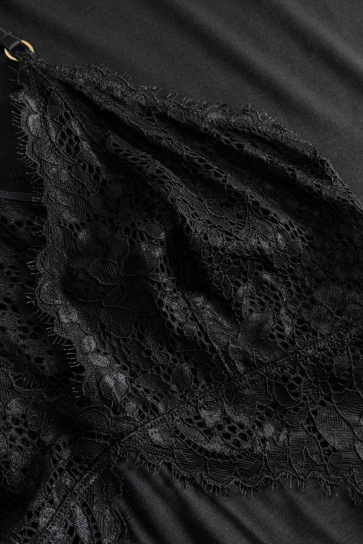 Close-up of black lace fabric with a dark background