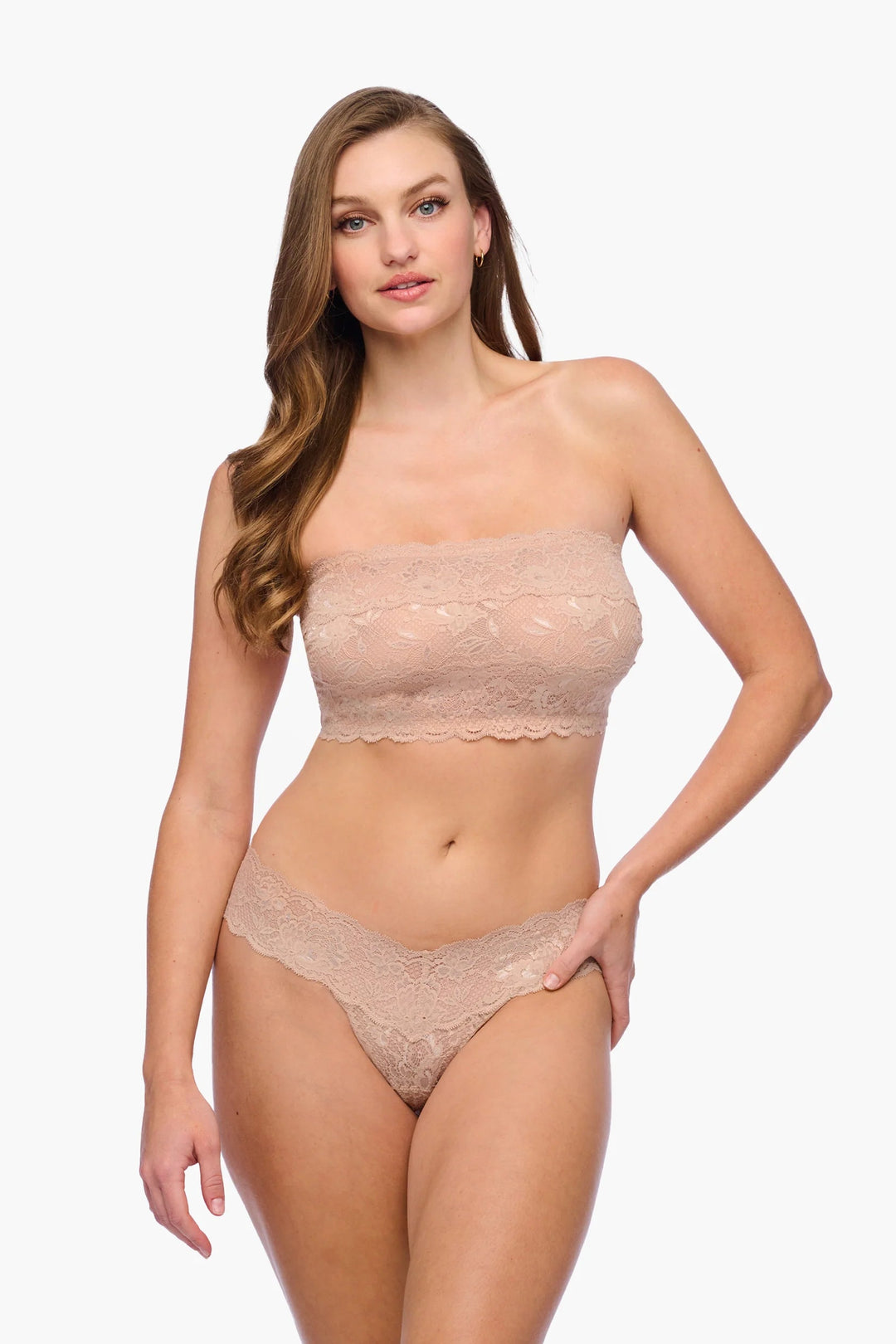 Woman wearing a beige strapless top and panties set on a white background