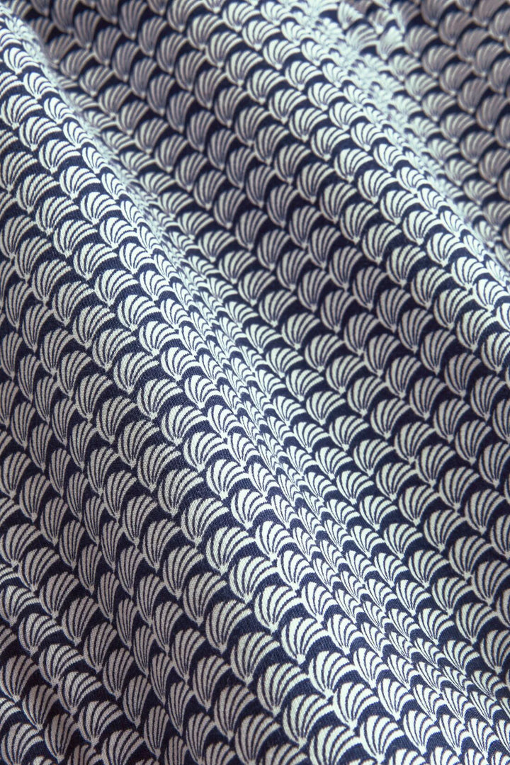 Textile with a wave seashell pattern in navy and white