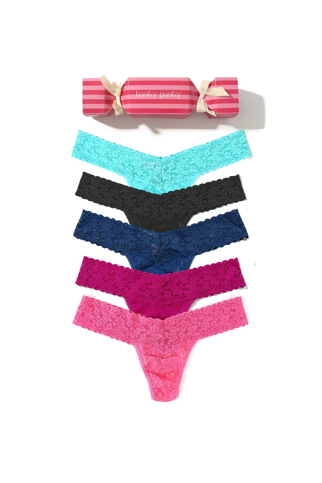 Set of colorful lace panties with a pink cracker box on a white background