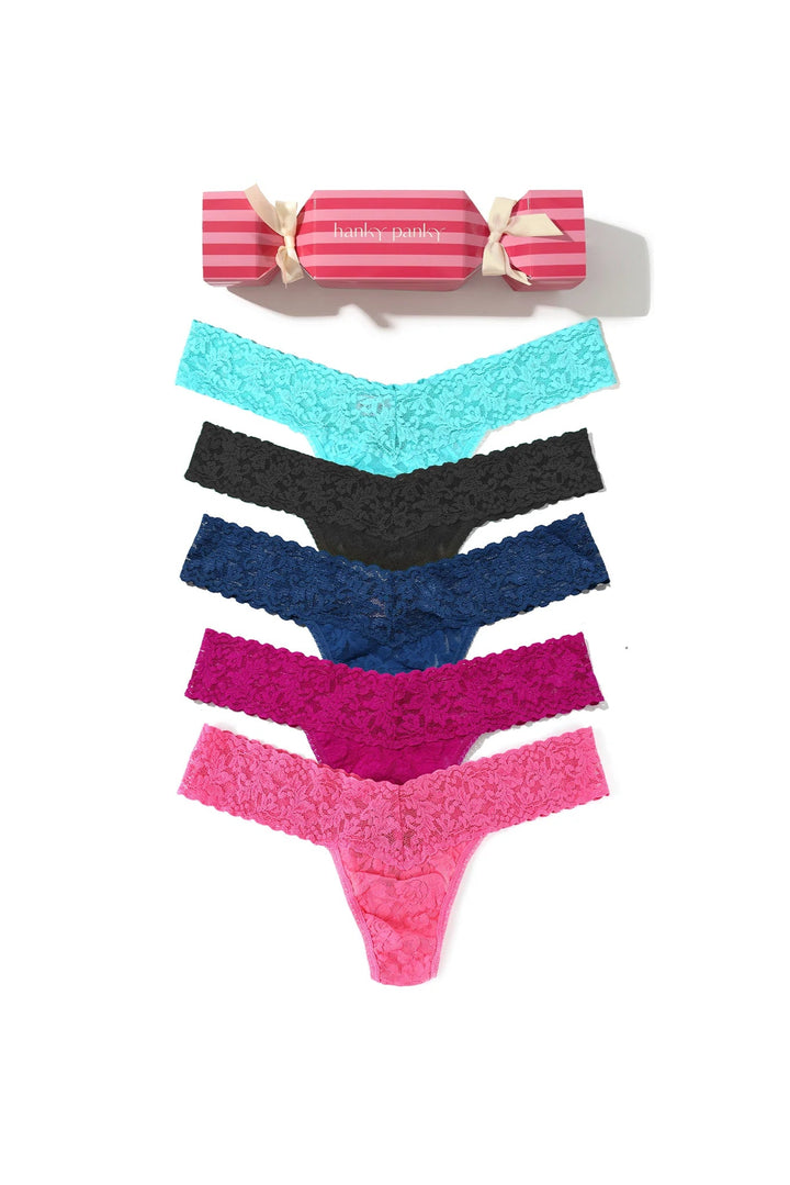 Set of colorful lace panties with a pink cracker box on a white background