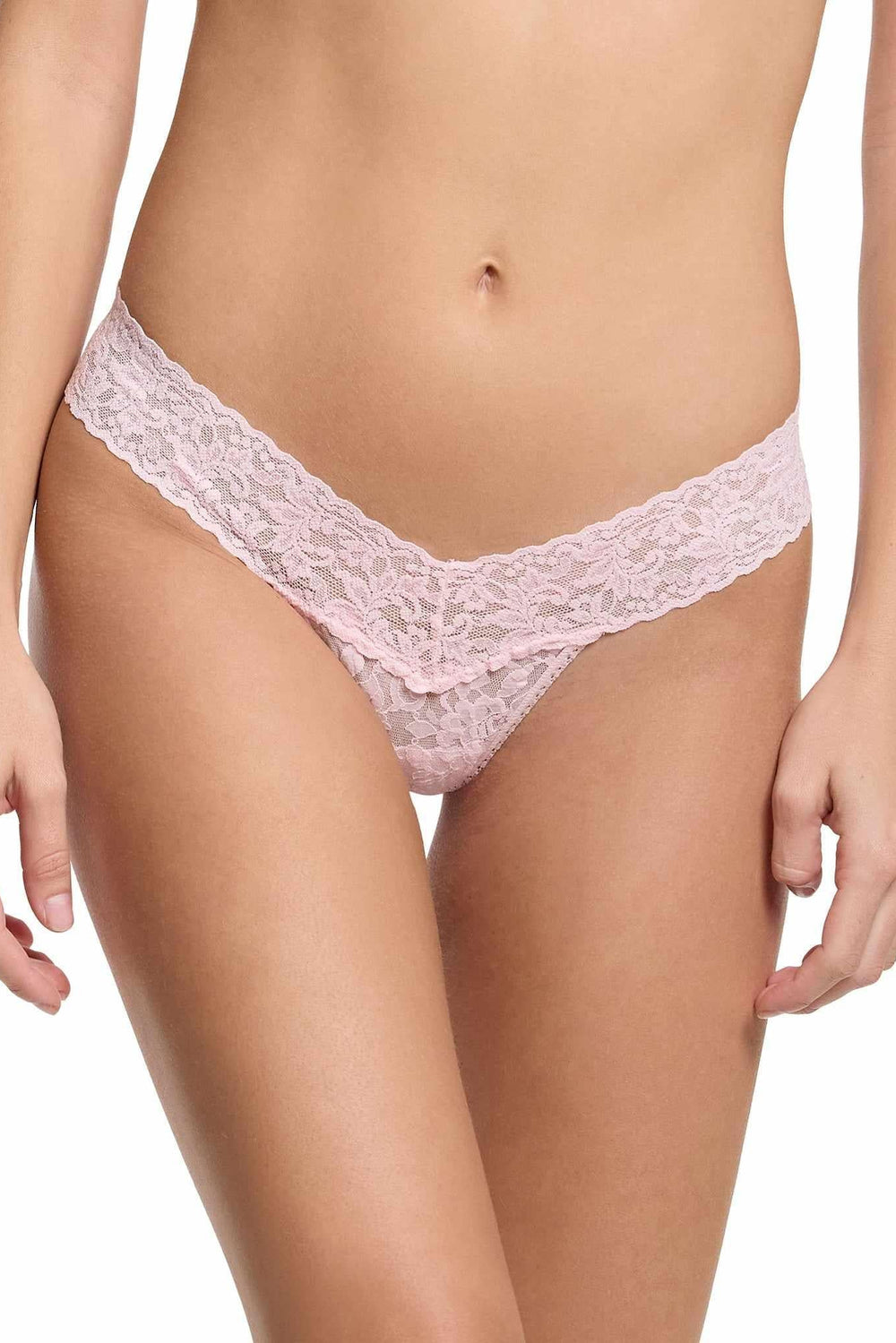 Pink lace thong worn by a person on a white background