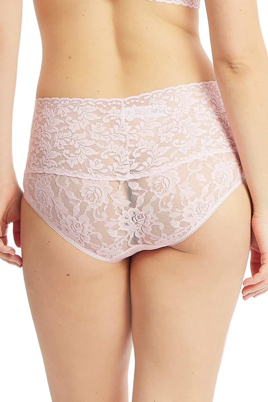 Lace underwear worn by a person on a white background