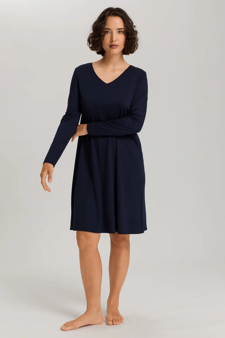 woman wearing a navy v-neck long sleeve A-line knee length night dress