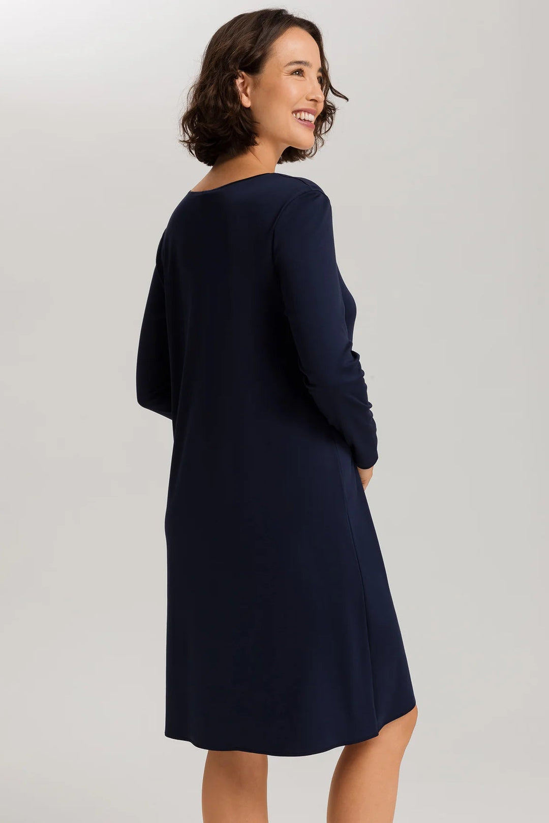 woman wearing a navy v-neck long sleeve A-line knee length night dress