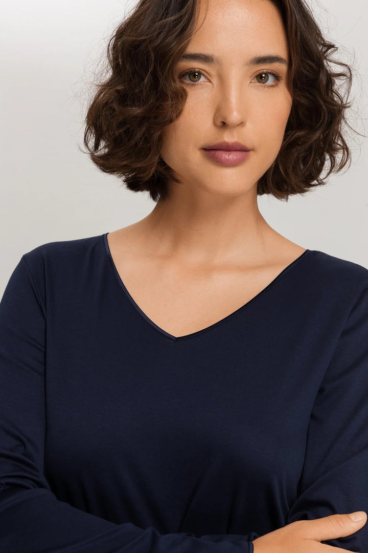 woman wearing a navy v-neck long sleeve A-line knee length night dress