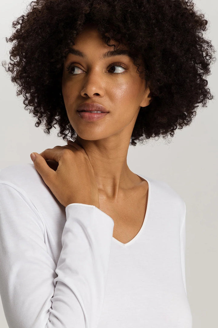 woman wearing a white v-neck long sleeve A-line knee length night dress