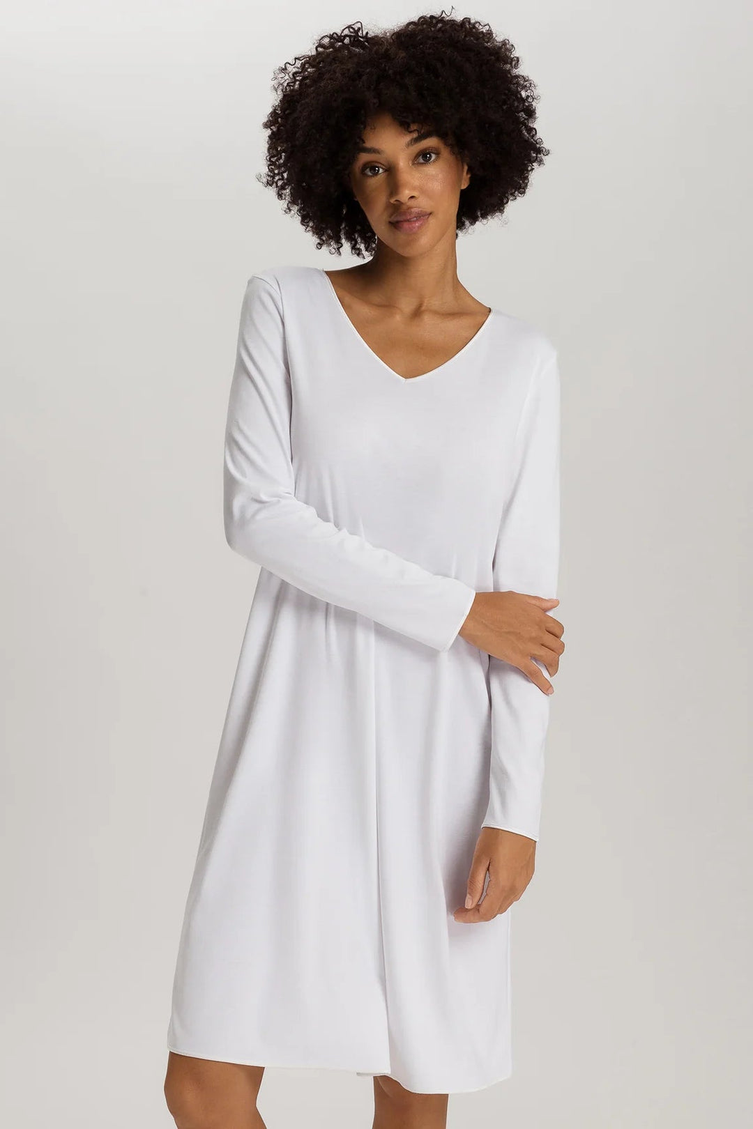 woman wearing a white v-neck long sleeve A-line knee length night dress