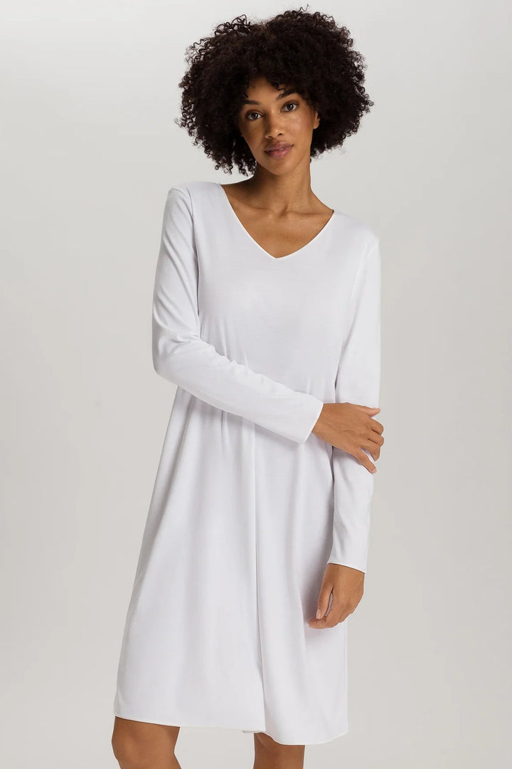 woman wearing a white v-neck long sleeve A-line knee length night dress
