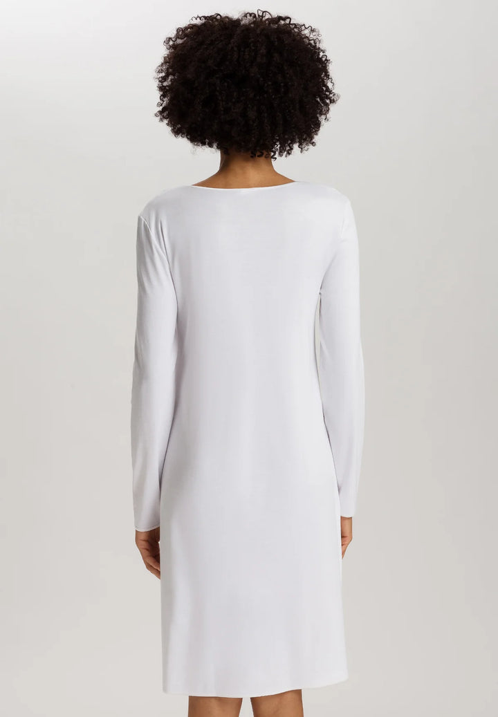 woman wearing a white v-neck long sleeve A-line knee length night dress